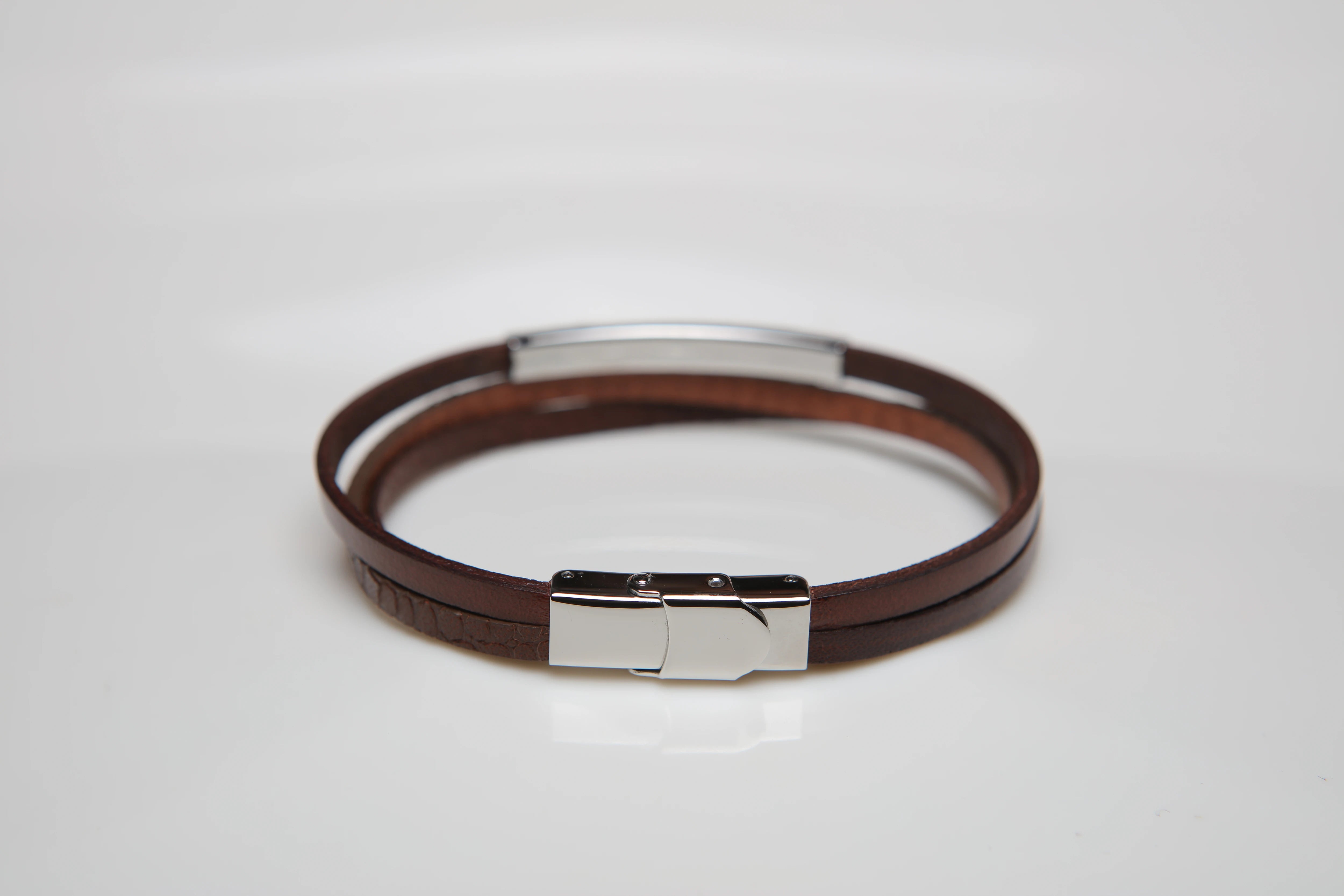 Stainless steel and leather bracelet with brown texture and gold screw