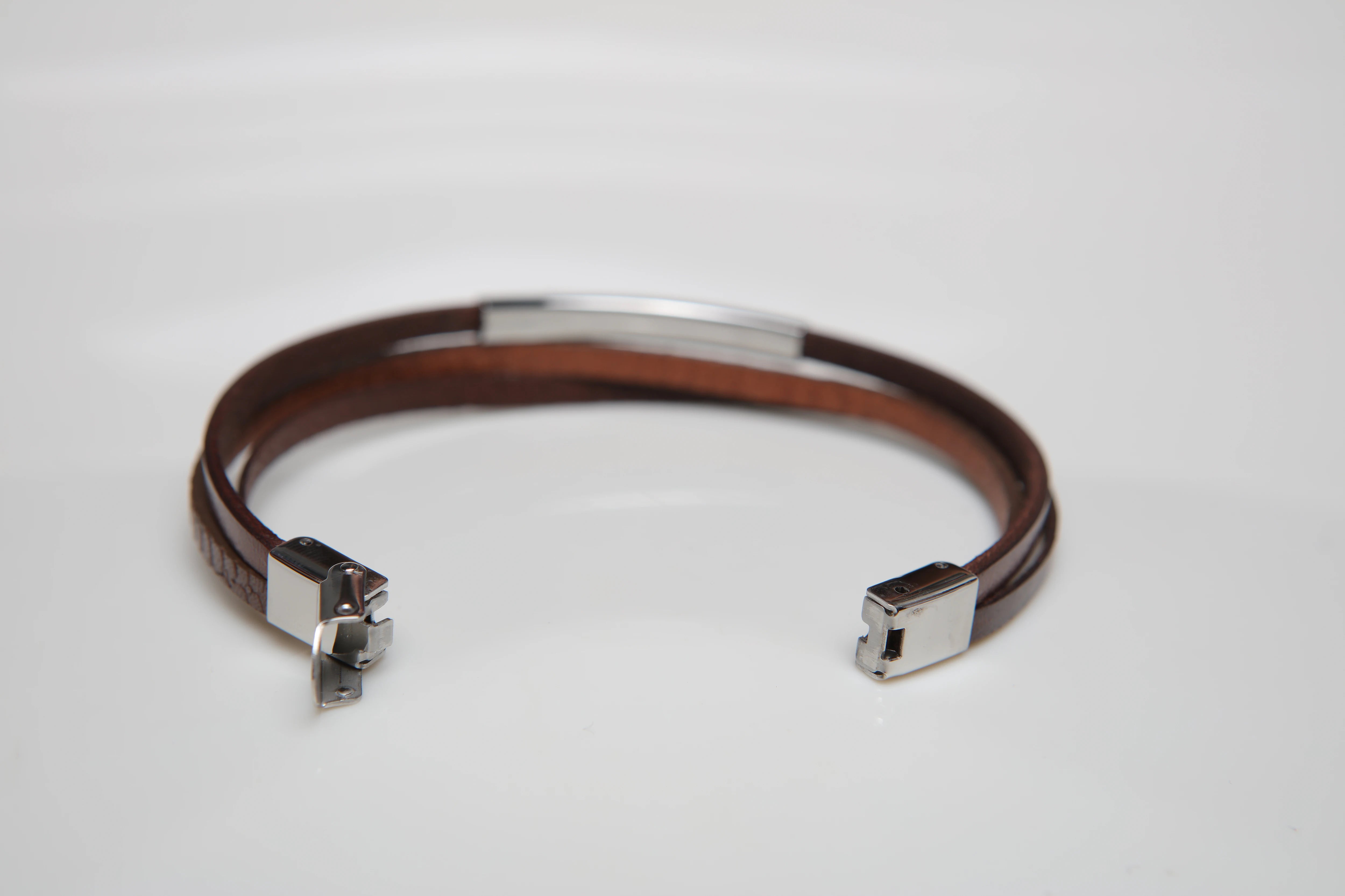 Stainless steel and leather bracelet with brown texture and gold screw