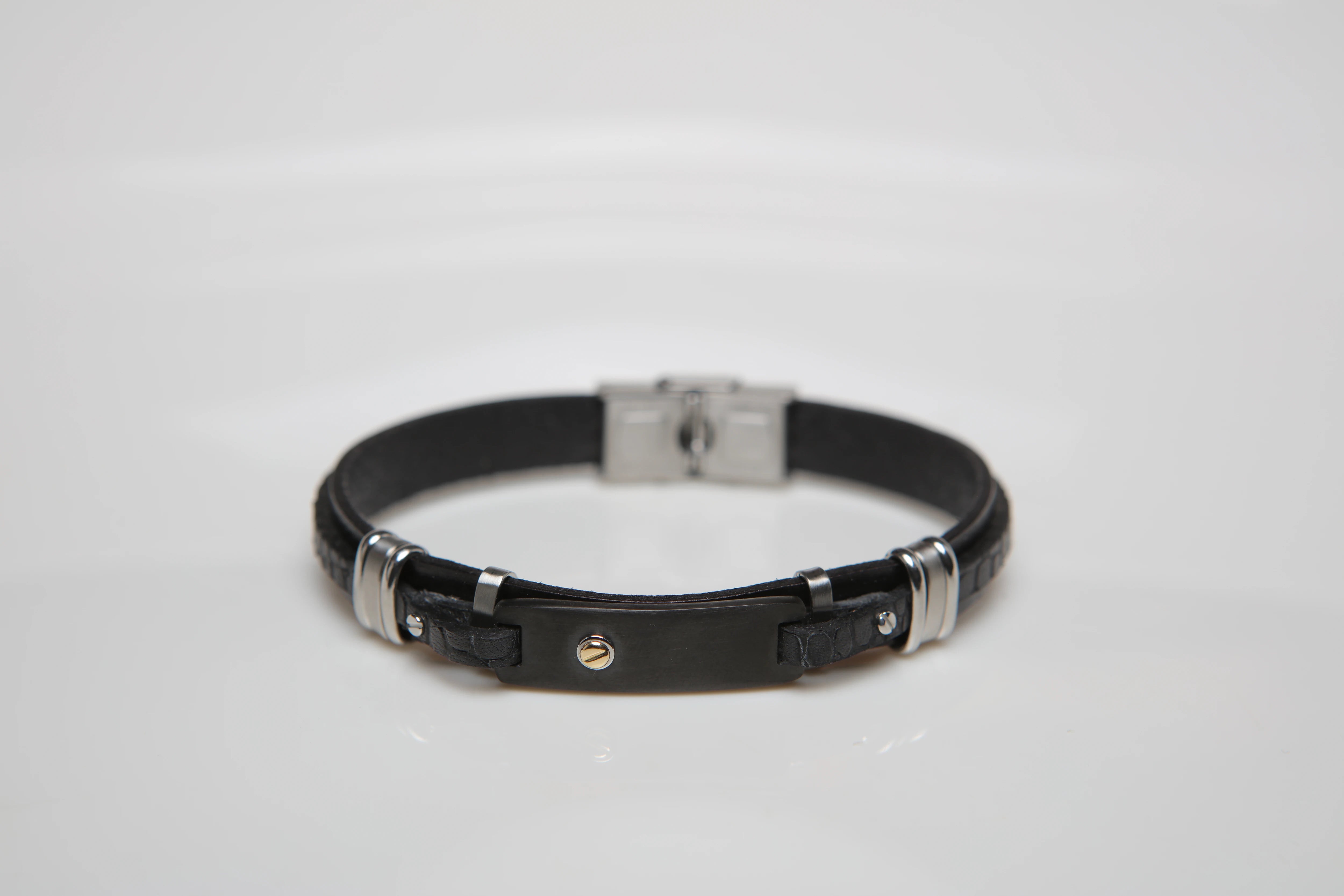 Stainless steel and leather bracelet with black texture and gold screw